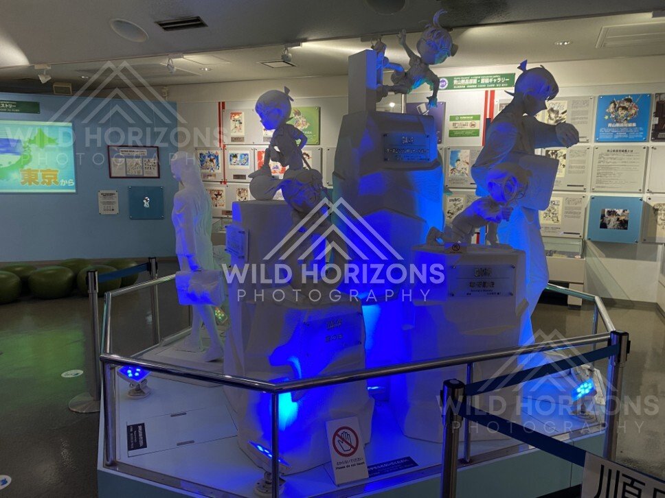 Blue-lit character sculpture installation inside the Gosho Aoyama Manga Factory. Hokuei, Japan.