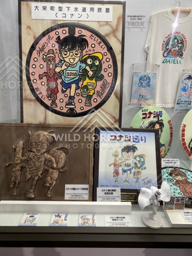 Detective Conan manhole cover exhibit display case at the Gosho Aoyama Manga Factory. Hokuei, Japan.