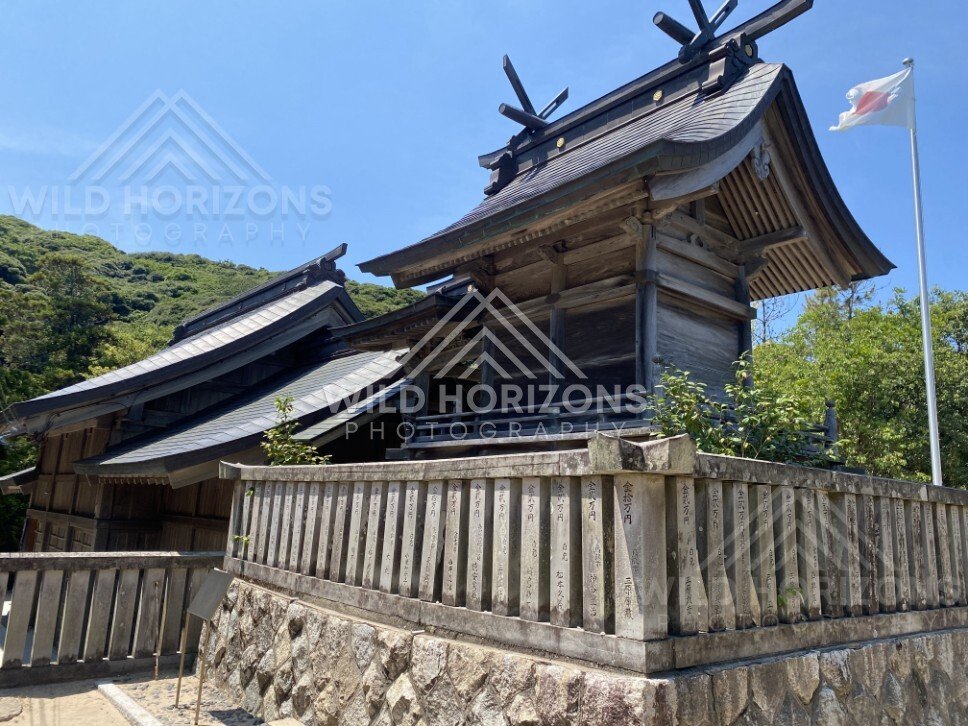 Hakuto Shrine Building With Flag and Forested Hills. Tottori, Japan.