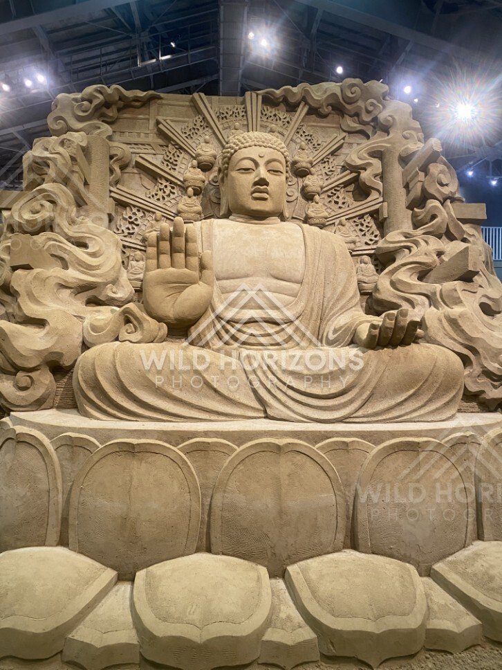 Sand Sculpture of Seated Buddha with Ornate Halo. Tottori Sand Museum, Japan.