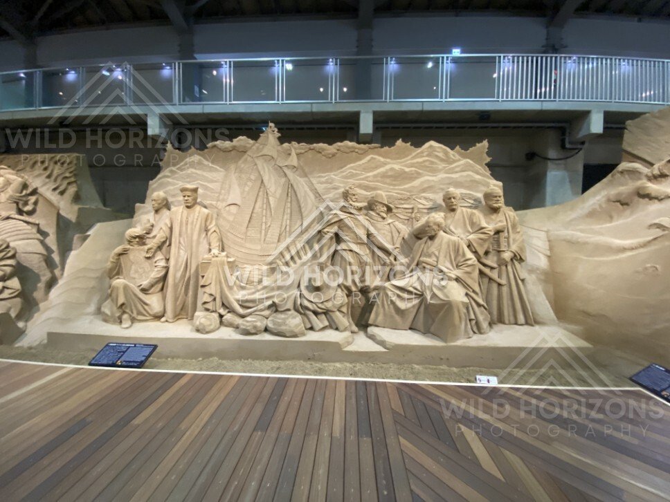 Sand Sculpture Tableau with Mountain Backdrop and Figures. Tottori Sand Museum, Japan.