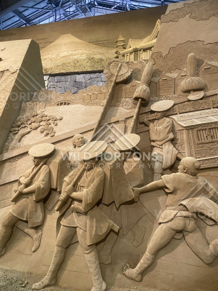 Sand Sculpture Procession with Straw Hats and Palanquin. Tottori Sand Museum, Japan.