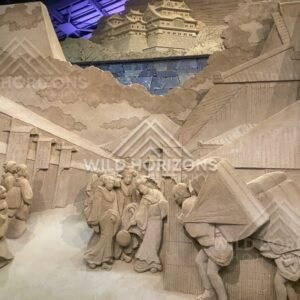 Sand Sculpture Relief of Crowded Scene Along Stone Wall. Tottori Sand Museum, Japan.