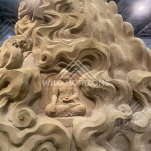 Sand Sculpture of a Buddha Figure Set Within Swirling Clouds. Tottori Sand Museum, Japan