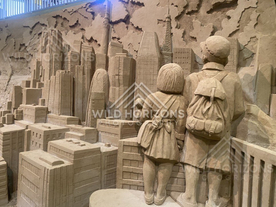 Sand Sculpture of Children Watching a Towering City Skyline. Tottori Sand Museum, Japan