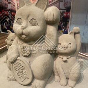 Sand Sculpture of Maneki-neko Lucky Cats Holding Coins. Tottori Sand Museum, Japan