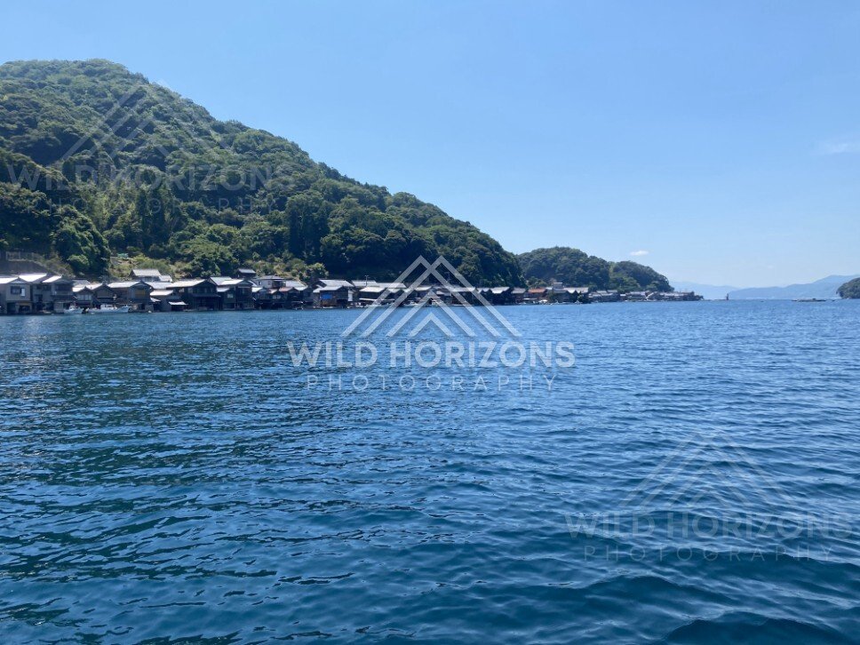 Open-water perspective of the bay with the village hugging the shoreline. Ine, Japan