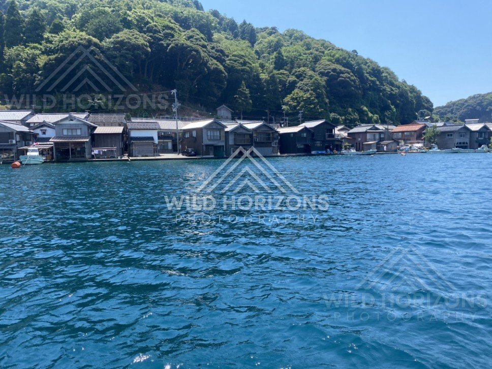 Colourful boathouse facades along the water’s edge in Ine. Ine, Japan