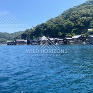Boathouses and steep green hills rising directly from the bay. Ine, Japan