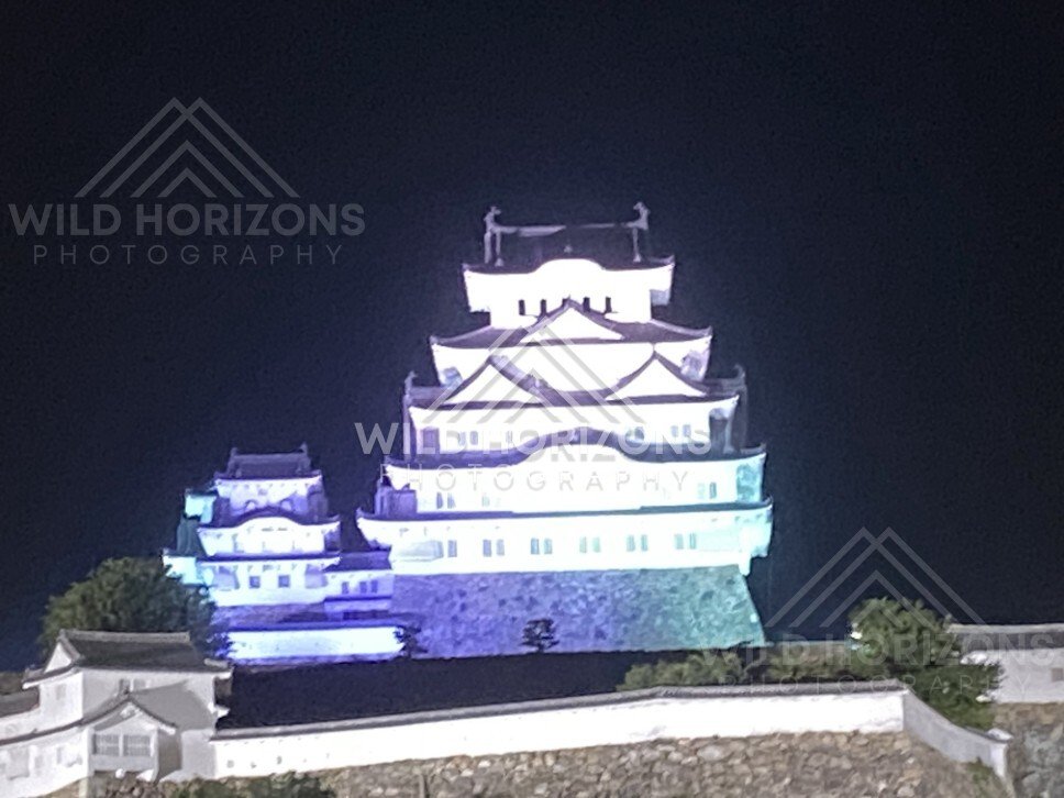 Floodlit Himeji Castle Keep Rising Above White Plaster Walls. Himeji Castle, Japan.