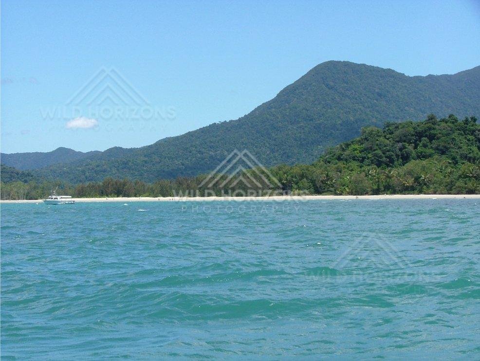 Tropical coastline with forested mountains above turquoise sea. Daintree Coastline, Australia.