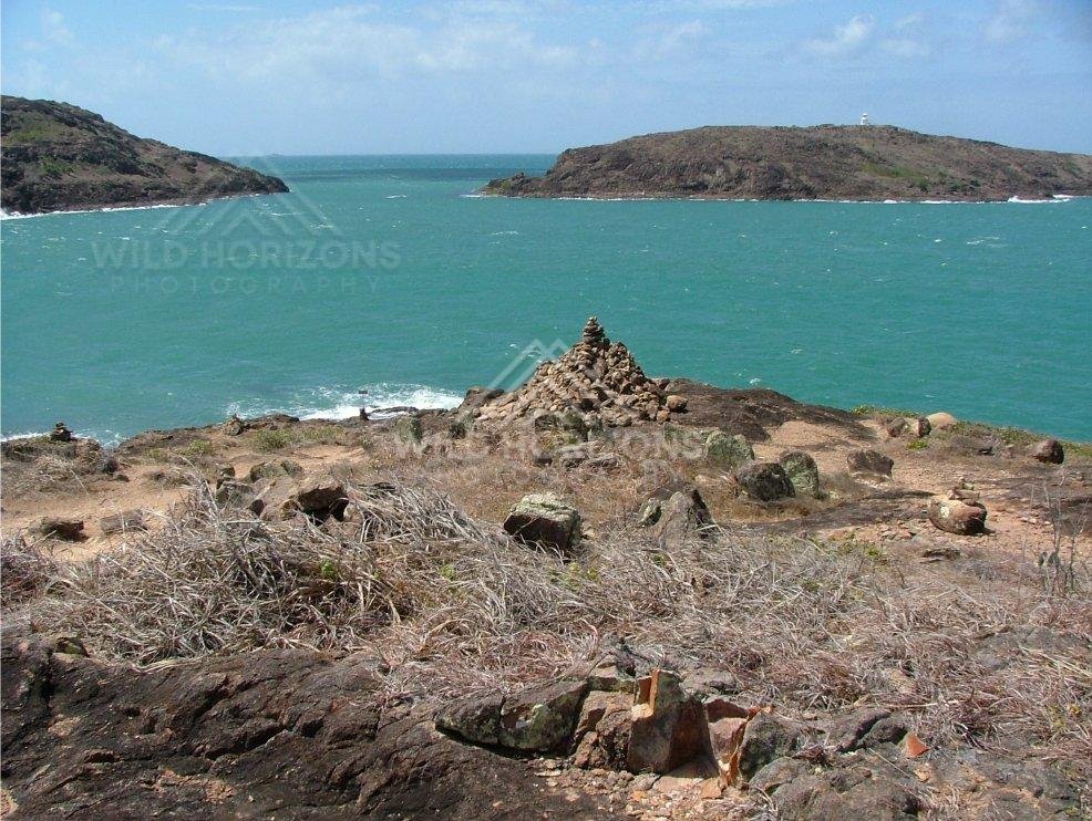 Stone cairn overlooking the Torres Strait from Cape York. Seisia, Australia.