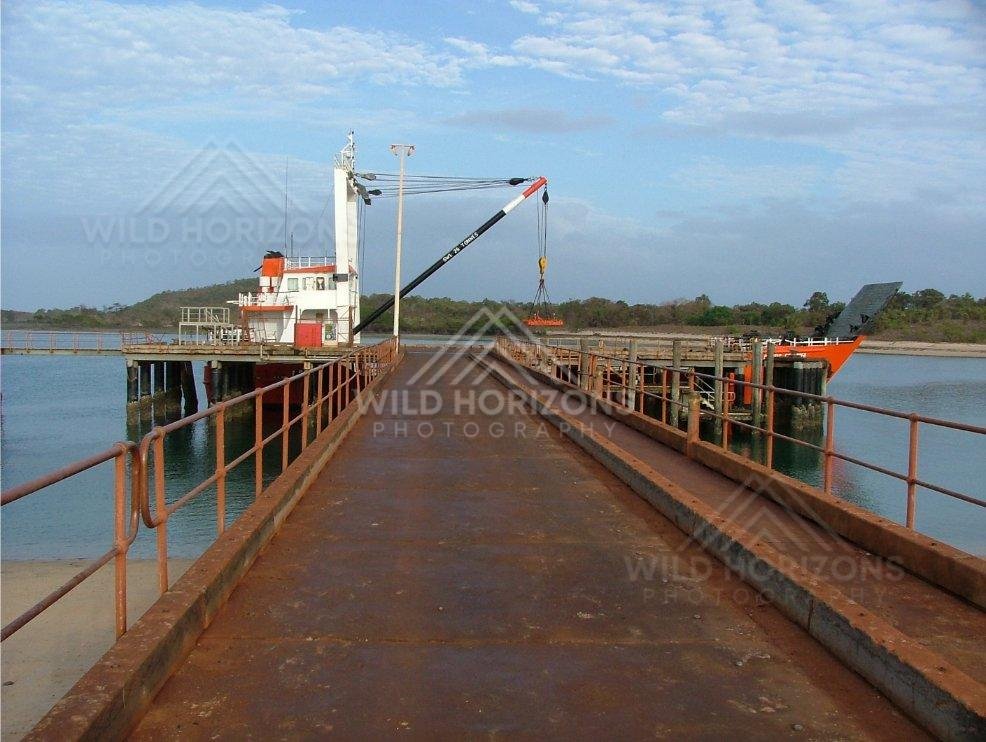 Industrial crane and loading jetty at Seisia Wharf. Seisia, Australia.