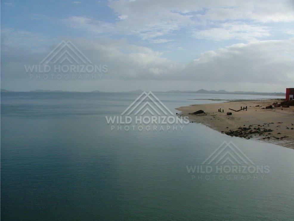 Quiet shoreline beside waterfront building at Seisia. Seisia, Australia.