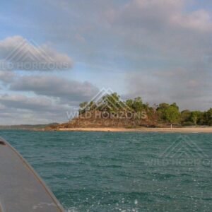 Approaching wooded headland by boat near Seisia. Seisia, Australia.