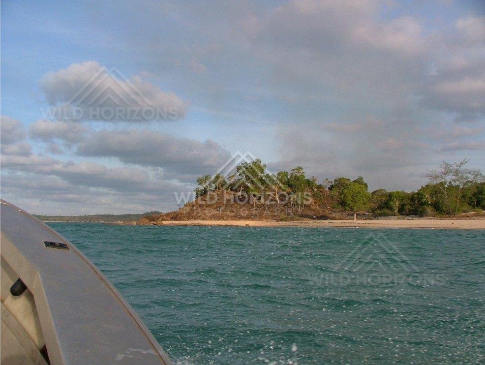 Approaching wooded headland by boat near Seisia. Seisia, Australia.