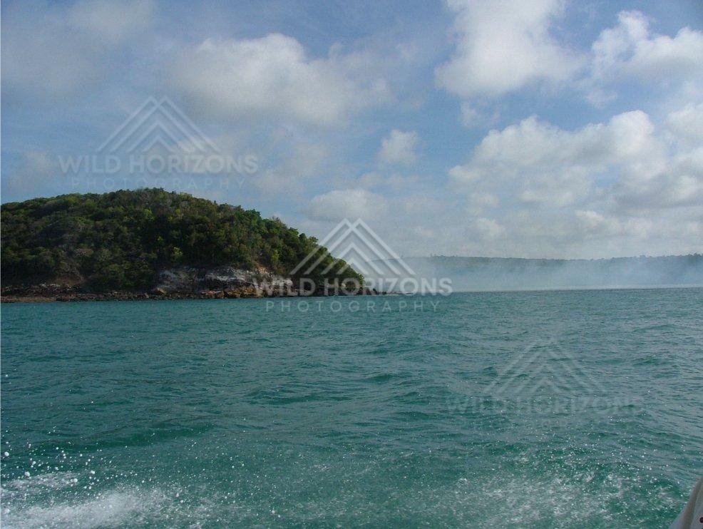 Forested headland viewed from coastal waters near Seisia. Seisia, Australia.