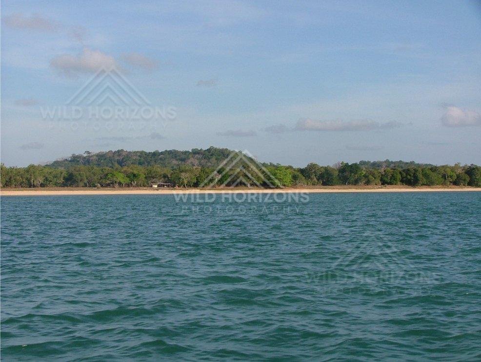 Distant sandy shoreline across open sea near Seisia. Seisia, Australia.