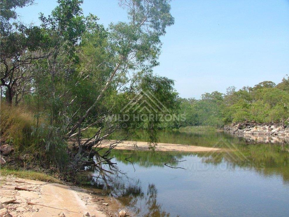 Tranquil bend of the Jardine River with sandy bank. Jardine River, Australia.