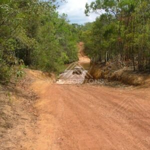 Four-wheel-drive track descending into a shallow creek crossing. Cape York, Australia.