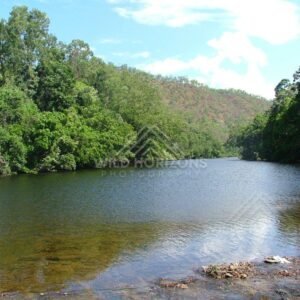 Along the Bloomfield River, clear tropical waters are bordered by dense rainforest. Bloomfield River, Australia.