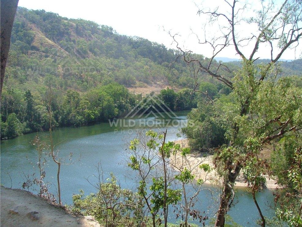 At the Bloomfield River, an elevated viewpoint overlooks green waters framed by rainforest slopes. Bloomfield River, Australia.