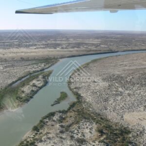 Aerial view of desert river approaching the Lake Eyre floodplain. Lake Eyre Basin, Australia.