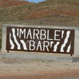 Steel cut-out town sign reading “Marble Bar” beside the highway. Marble Bar, Australia.
