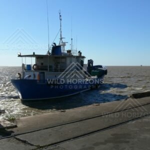 Small coastal workboat moored at the concrete ramp. Normanton, Queensland, Australia.