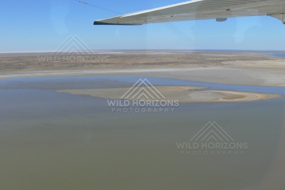 Expansive lake waters fading into salt horizons. Lake Eyre Basin, Australia.