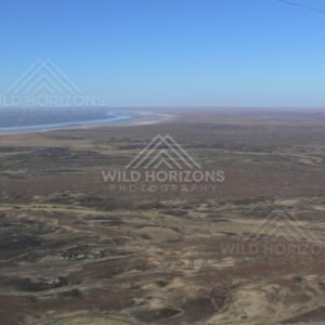 Stony desert country beside distant lake edge. Lake Eyre Basin, Australia.