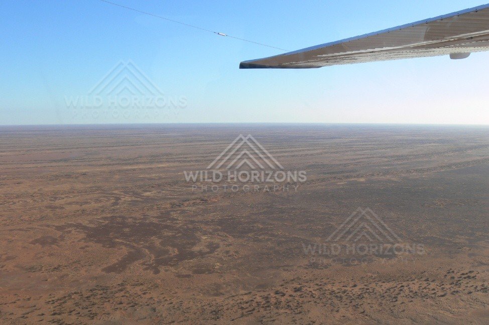 Endless gibber plains approaching Kati Thanda–Lake Eyre. Lake Eyre Basin, Australia.
