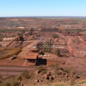 Elevated overview of iron-ore processing plant and rail loading facilities. Pilbara, Australia.