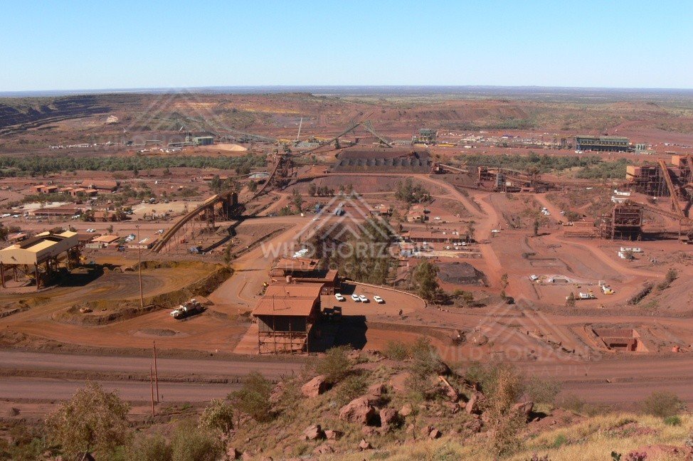 Elevated overview of iron-ore processing plant and rail loading facilities. Pilbara, Australia.