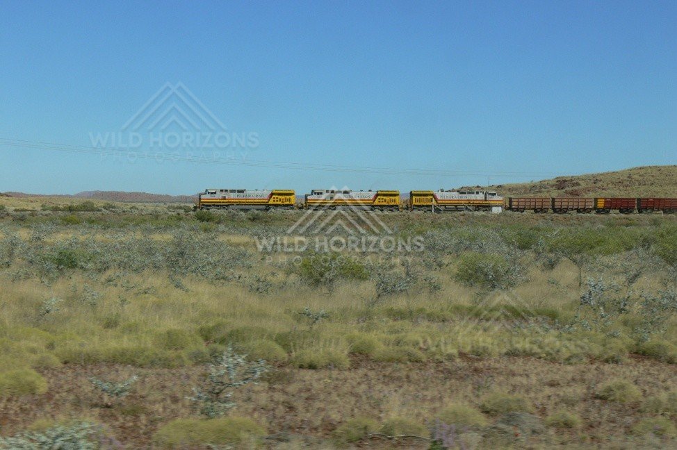 Iron-ore train departing the Pilbara near Tom Price. Pilbara, Australia.