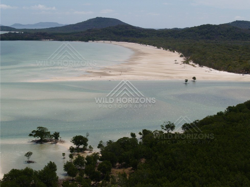 Sweeping sand flats and inlet with forested hills beyond. Cape York, Queensland, Australia.