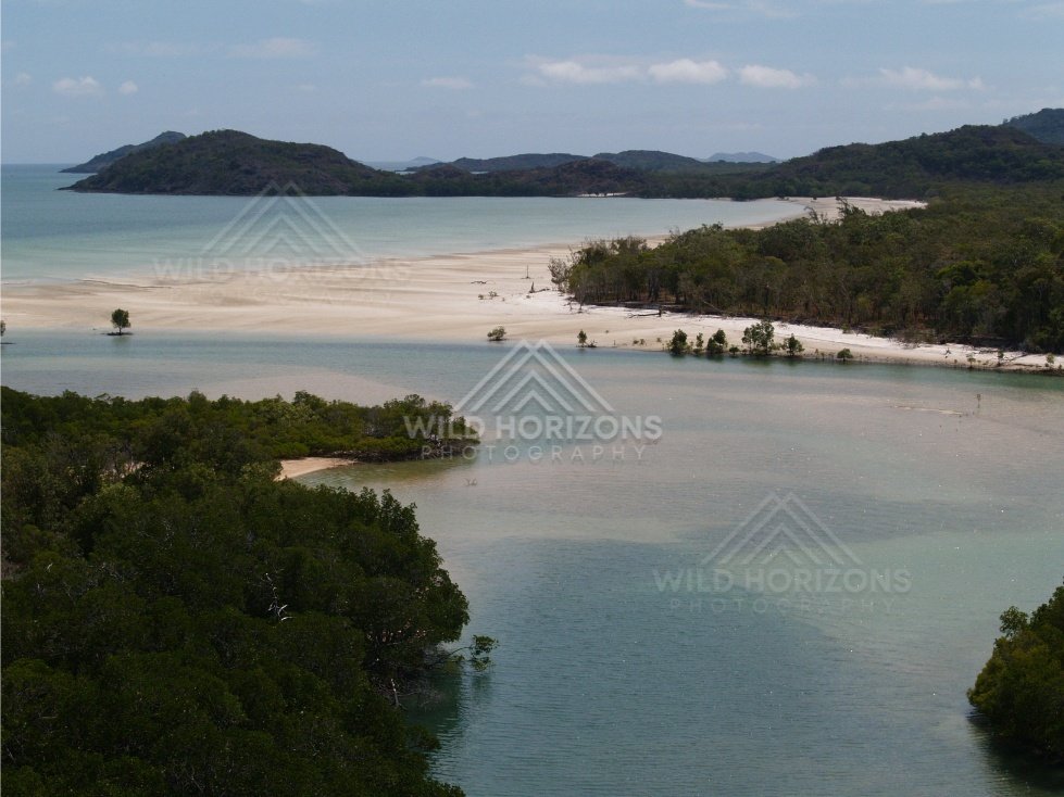 Sandy lagoon and forested peninsula from the air. Cape York, Queensland, Australia.