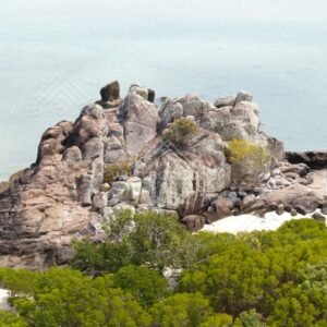 Granite coastal rocks with light surf. Cape York, Queensland, Australia.