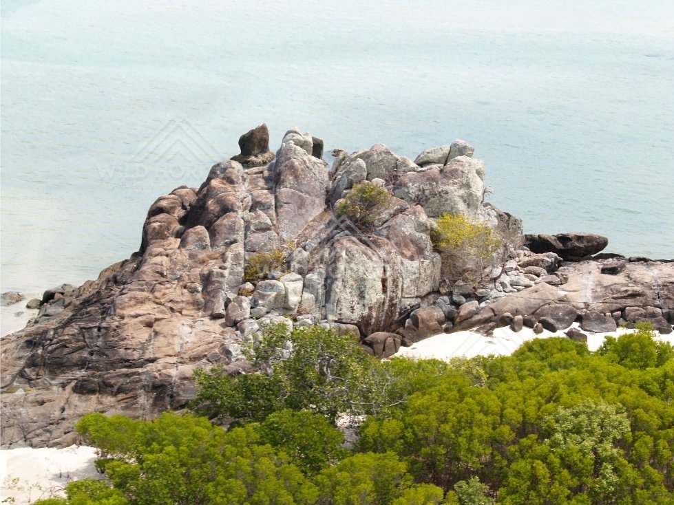 Granite coastal rocks with light surf. Cape York, Queensland, Australia.