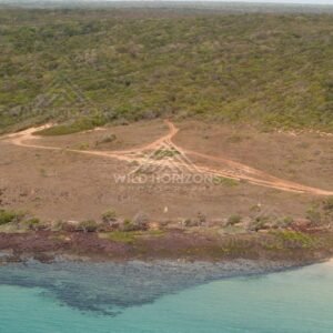 Sandy point and dirt tracks on coastal plateau. Narau Beach, Queensland, Australia.