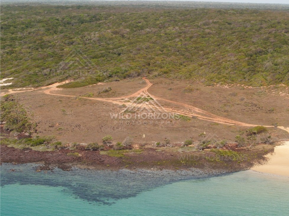 Sandy point and dirt tracks on coastal plateau. Narau Beach, Queensland, Australia.