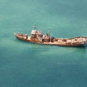 Rusted shipwreck lying offshore. Seisia, Queensland, Australia.