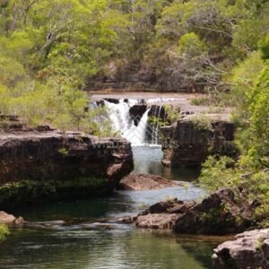 Wide waterfall with deep green pool below. Fruitbat Falls, Queensland, Australia.