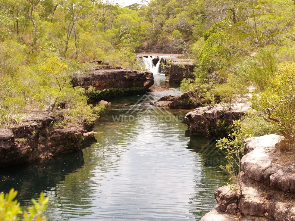 Creek channel with distant falls. Fruitbat Falls, Queensland, Australia.