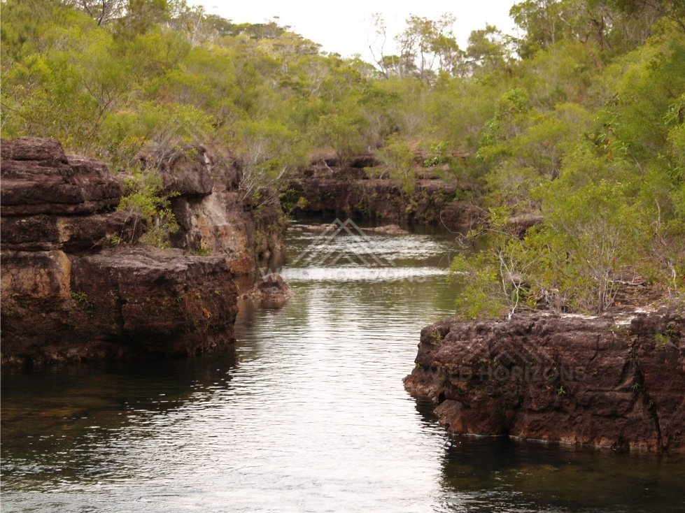 Quiet river reach with sandstone banks. Fruitbat Falls, Queensland, Australia.