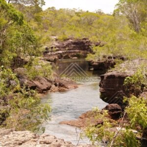 Creek between sandstone banks with gentle flow. Fruitbat Falls, Queensland, Australia.