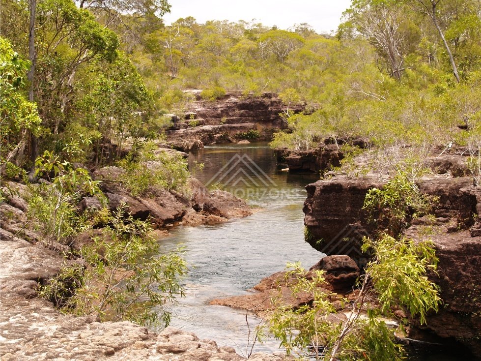 Creek between sandstone banks with gentle flow. Fruitbat Falls, Queensland, Australia.