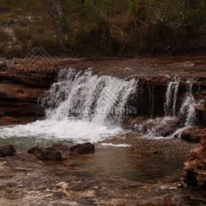 Low waterfall with broad rock apron. Fruitbat Falls, Queensland, Australia.