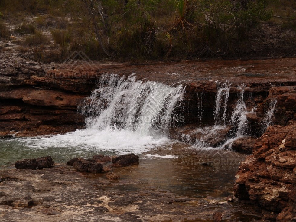 Low waterfall with broad rock apron. Fruitbat Falls, Queensland, Australia.