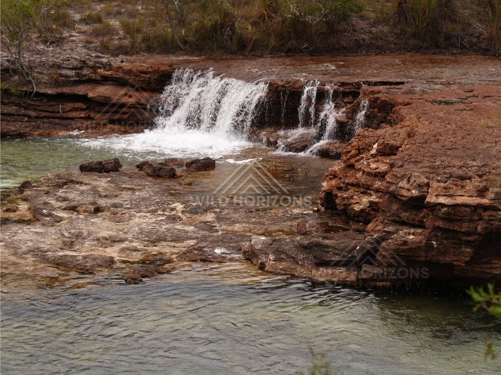 Step cascade across sandstone terrace. Fruitbat Falls, Queensland, Australia.